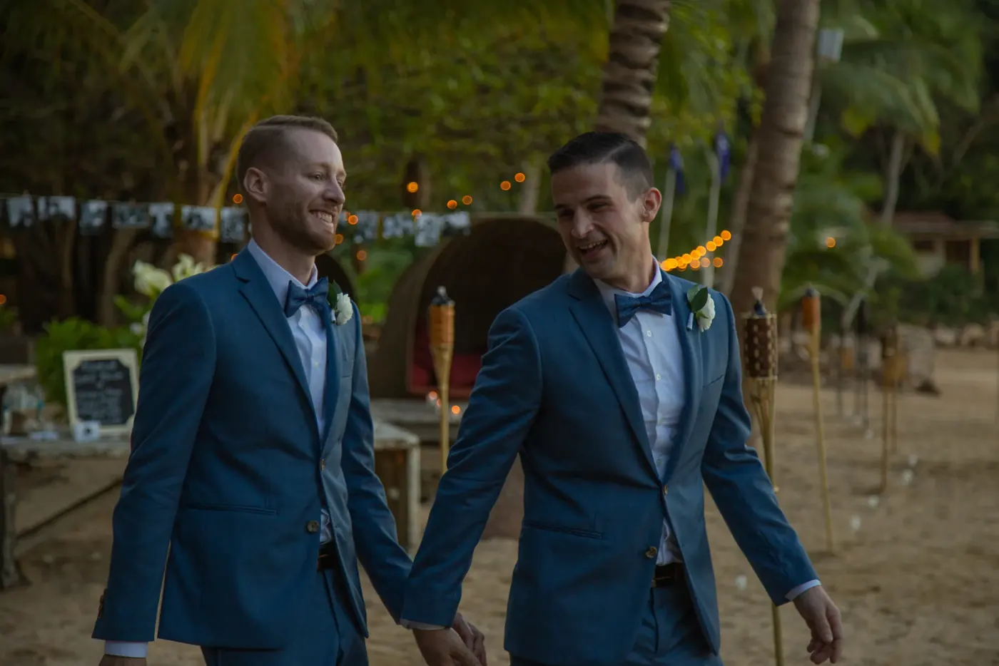 Two grooms walking hand in hand